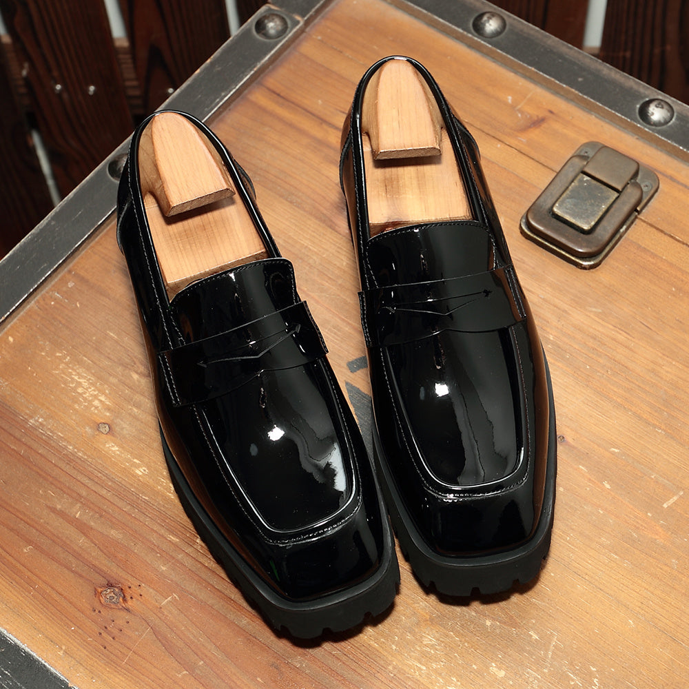 Black patent leather penny loafers showcasing luxury fashion for all in high-end fashion online